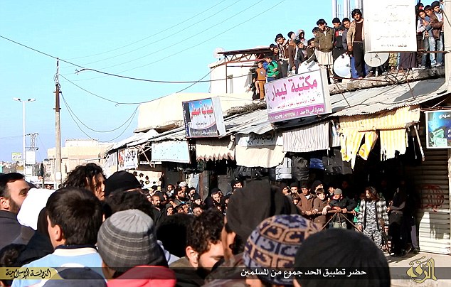 Spectators: The baying crowd are seen clambering on to rooftops to get a better view of the savage scene