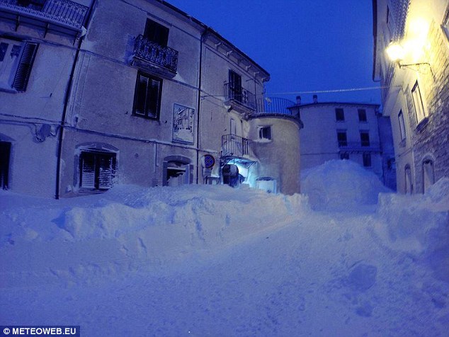 The clear sky and white snow gave off an eerie blue effect in the village when night fell