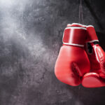 Pair of red boxing gloves hanging